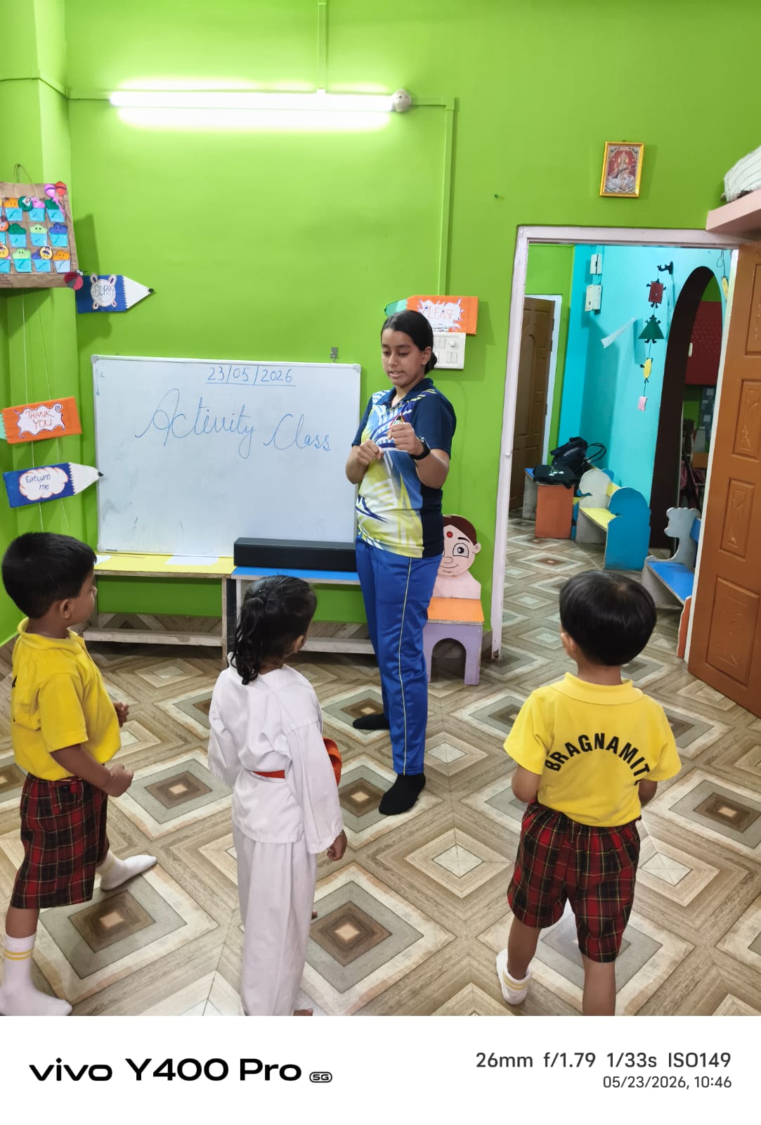 Teacher giving personalised attention to a small group of children at Buds & Blossoms